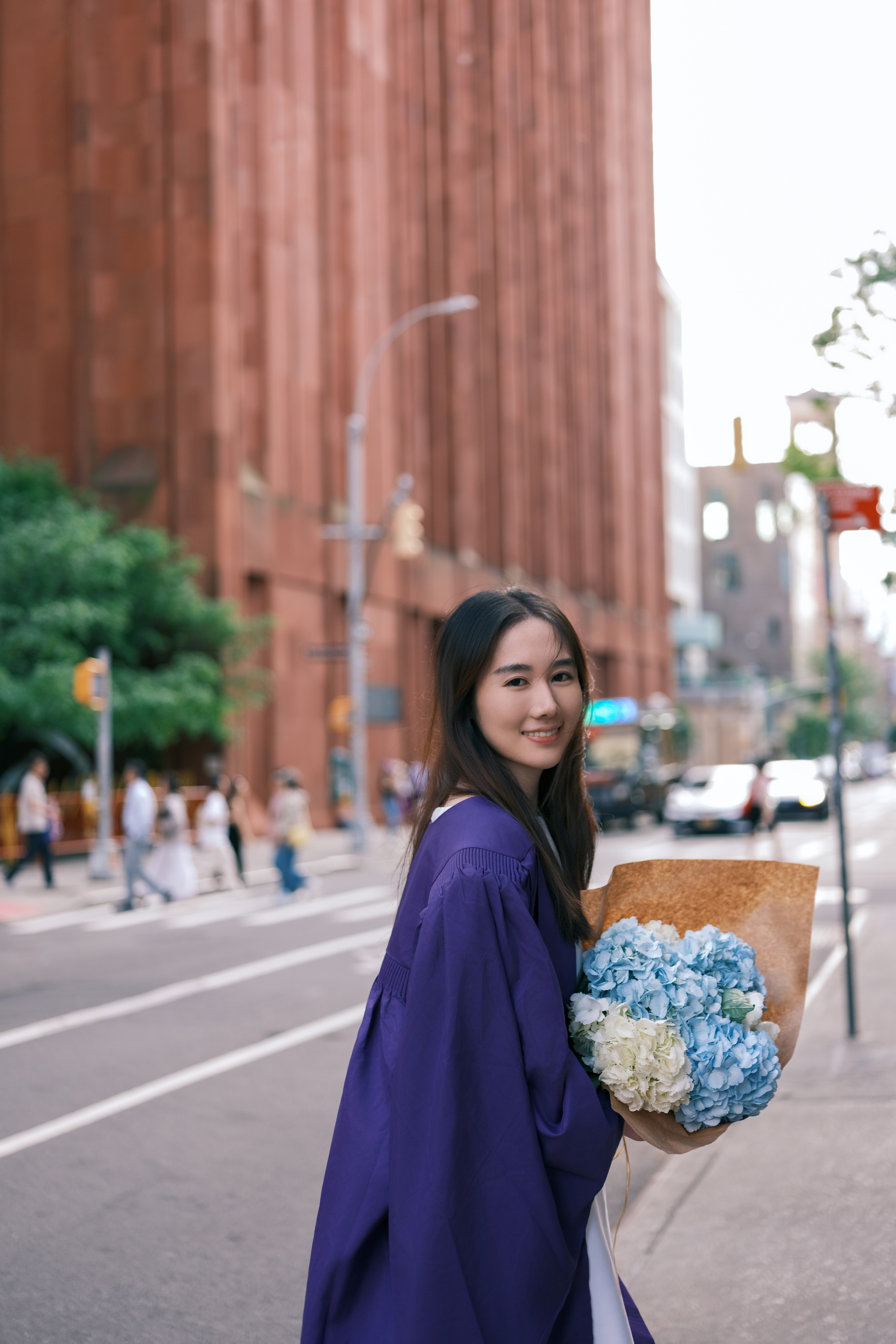 Close-up portrait of a smiling woman with long brown hair