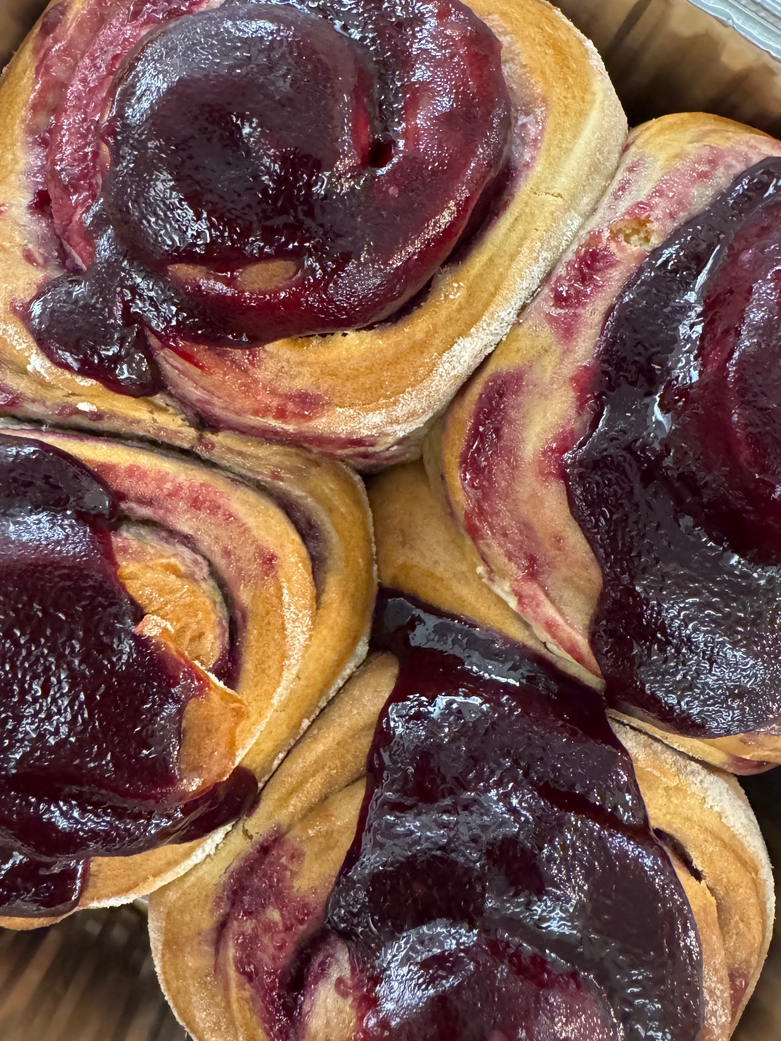 sourdough cinnamon rolls in a box squeezed against one another