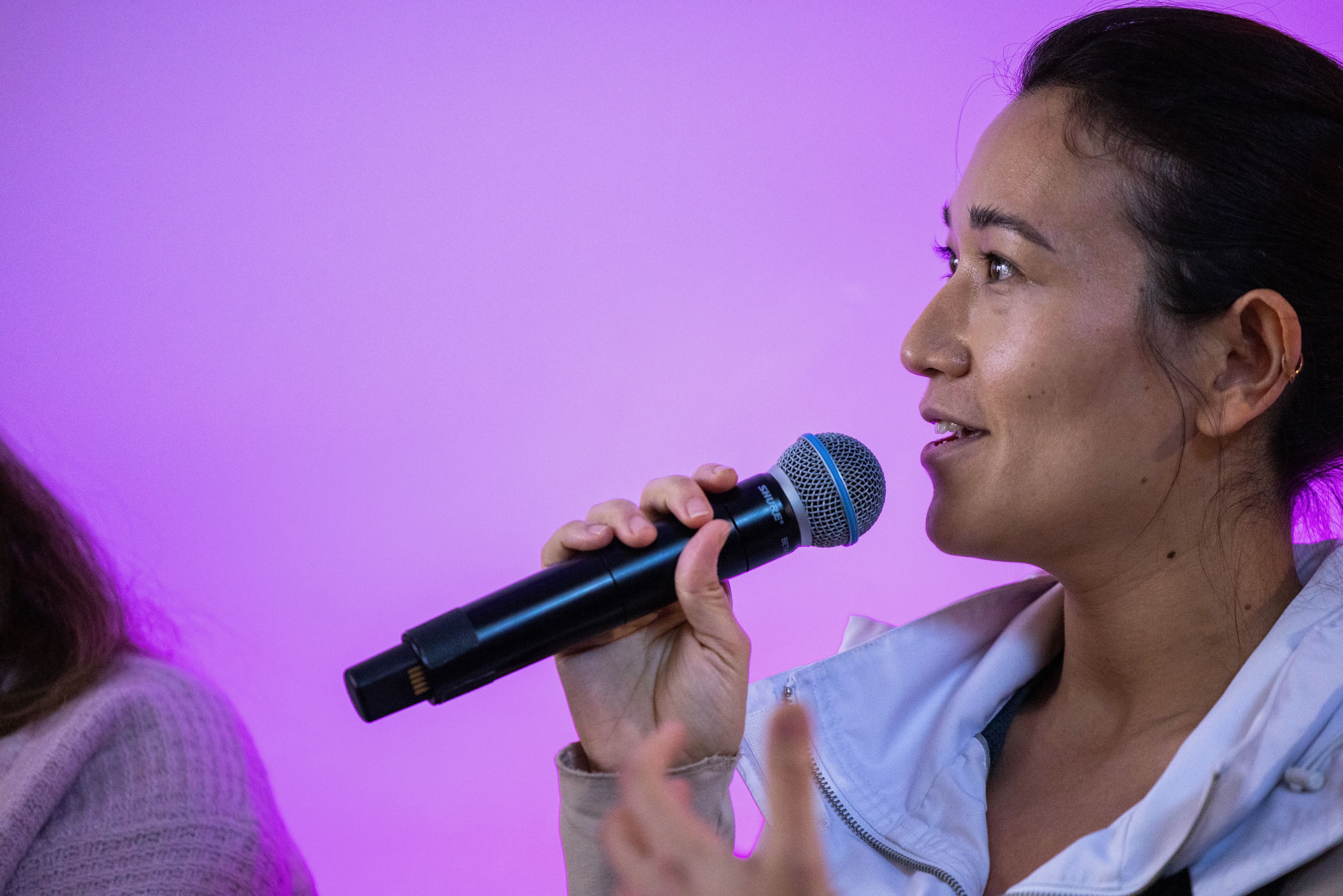 A woman talking into a microphone at the Artificiality Summit