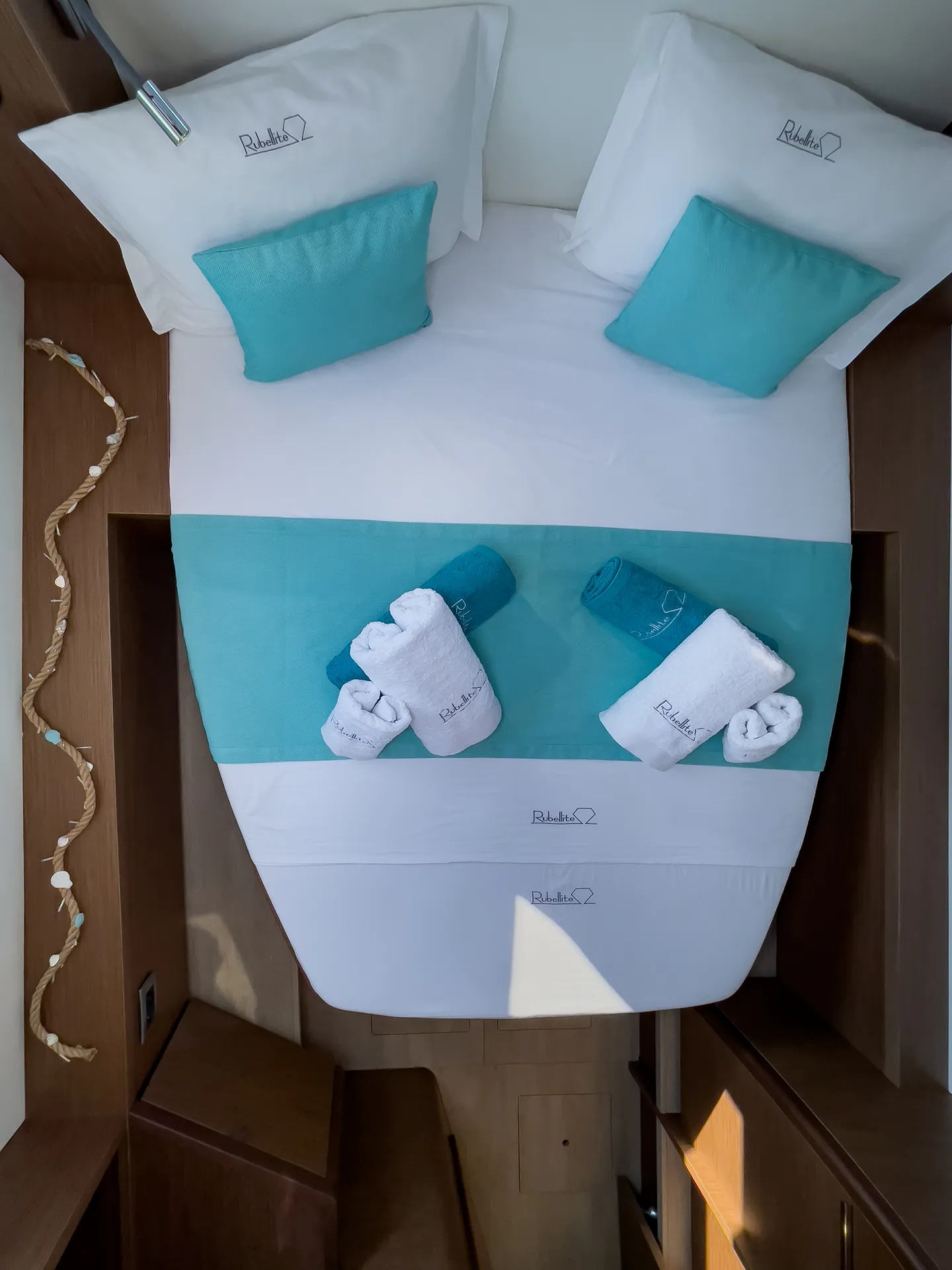 White Rock 36 speedboat with captain at helm cruising calm blue waters near Paros coastline with hills in background.