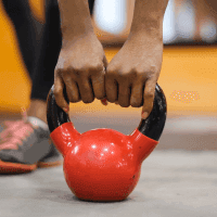 Hands holding a kettlebell