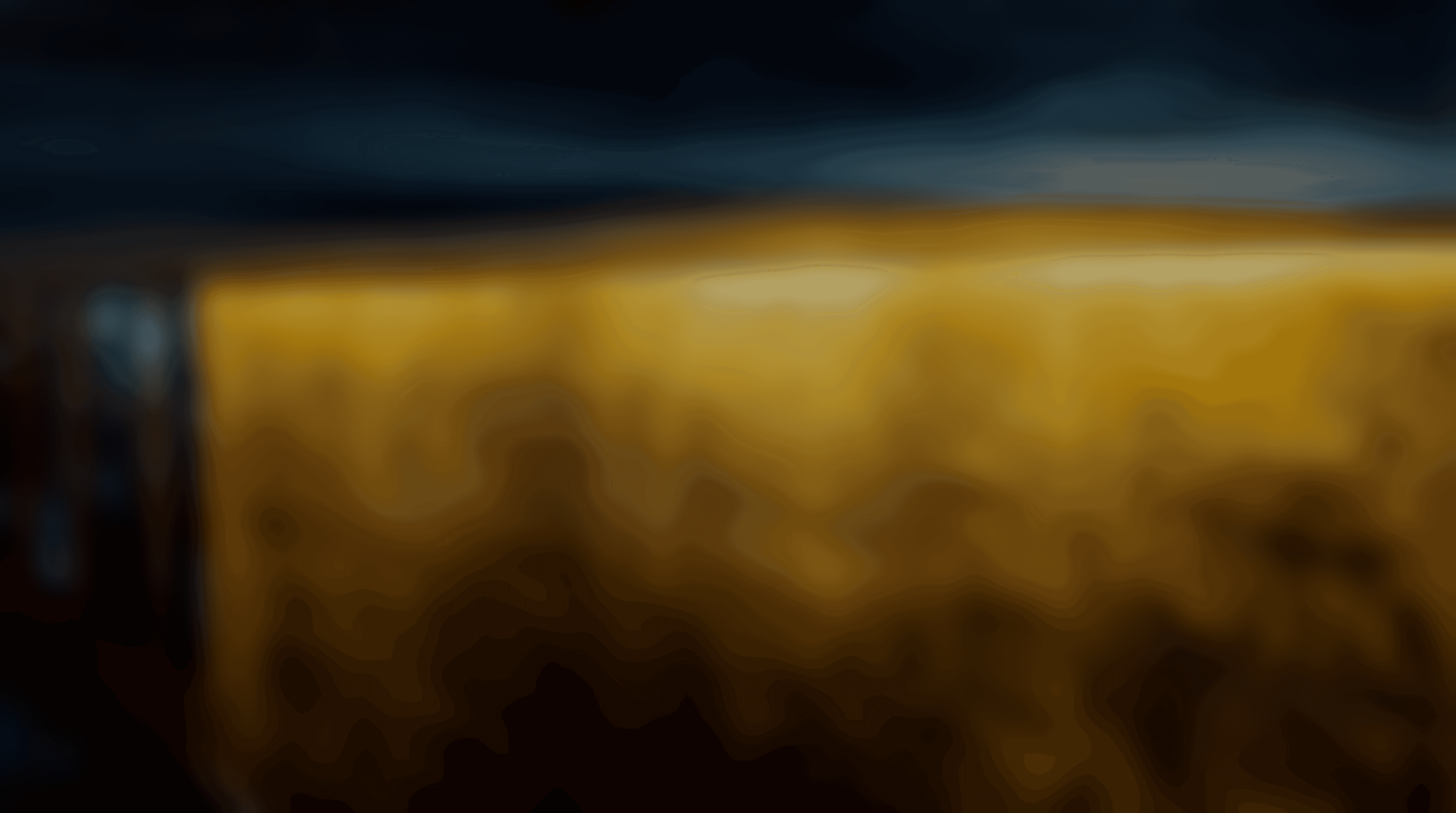 Asphallt oben und darunter einer gold beleuchtete Wand. Das Bild hatv einen Blur Filter