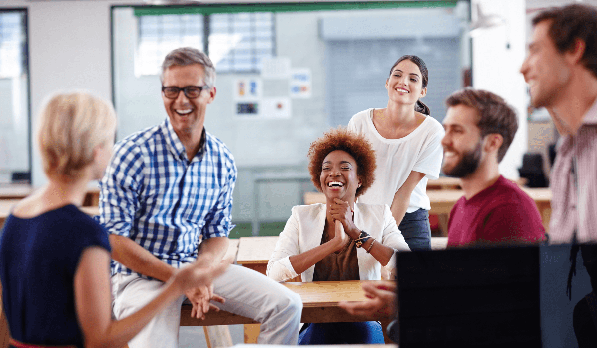 Some people sitting and talking in a classroom.