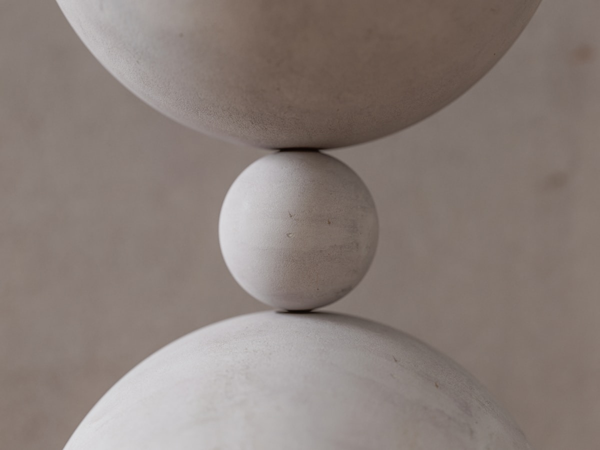 Two limestone spheres meeting at a single point