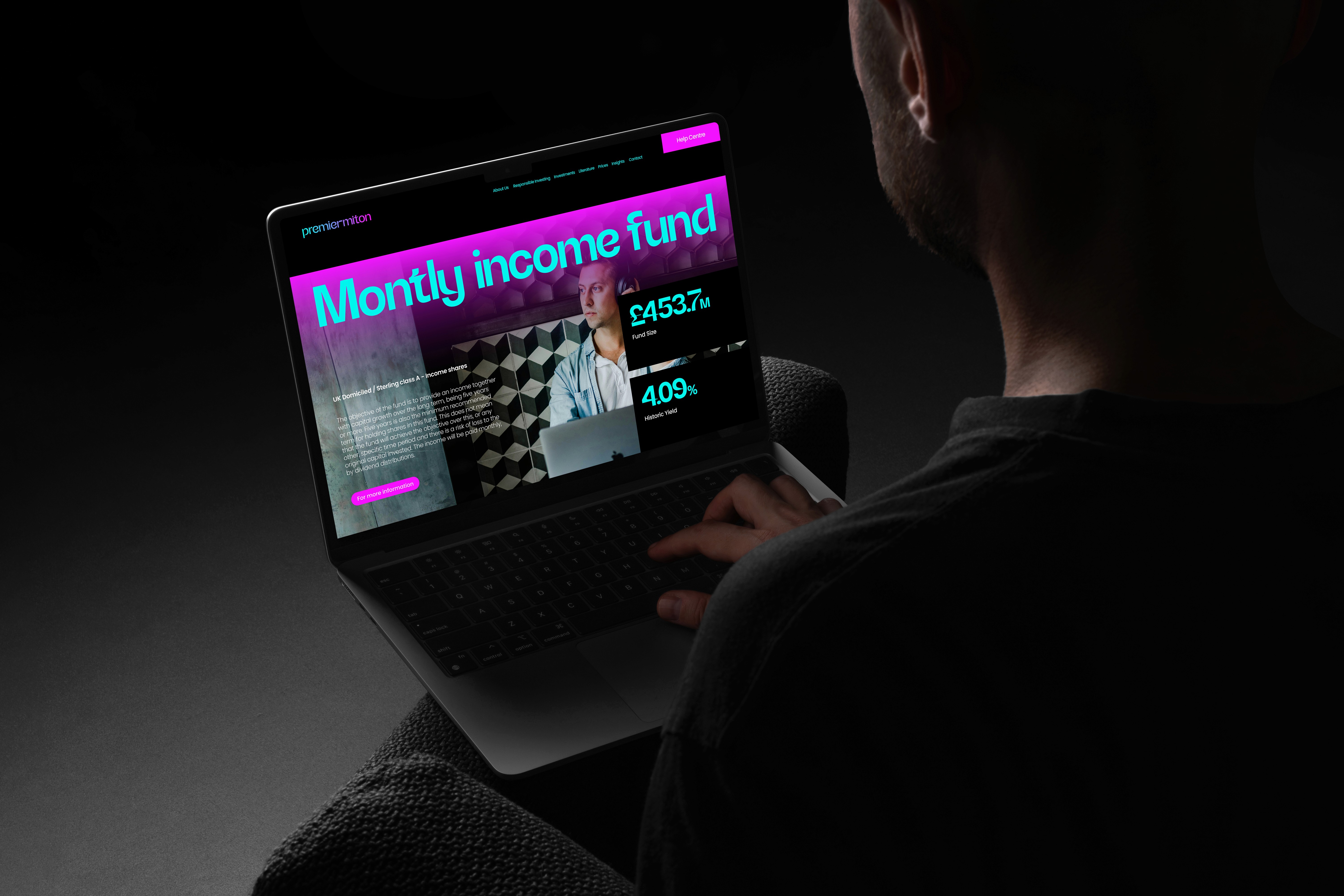 Man holing iPad showcasing Premier Miton web design concept screen.