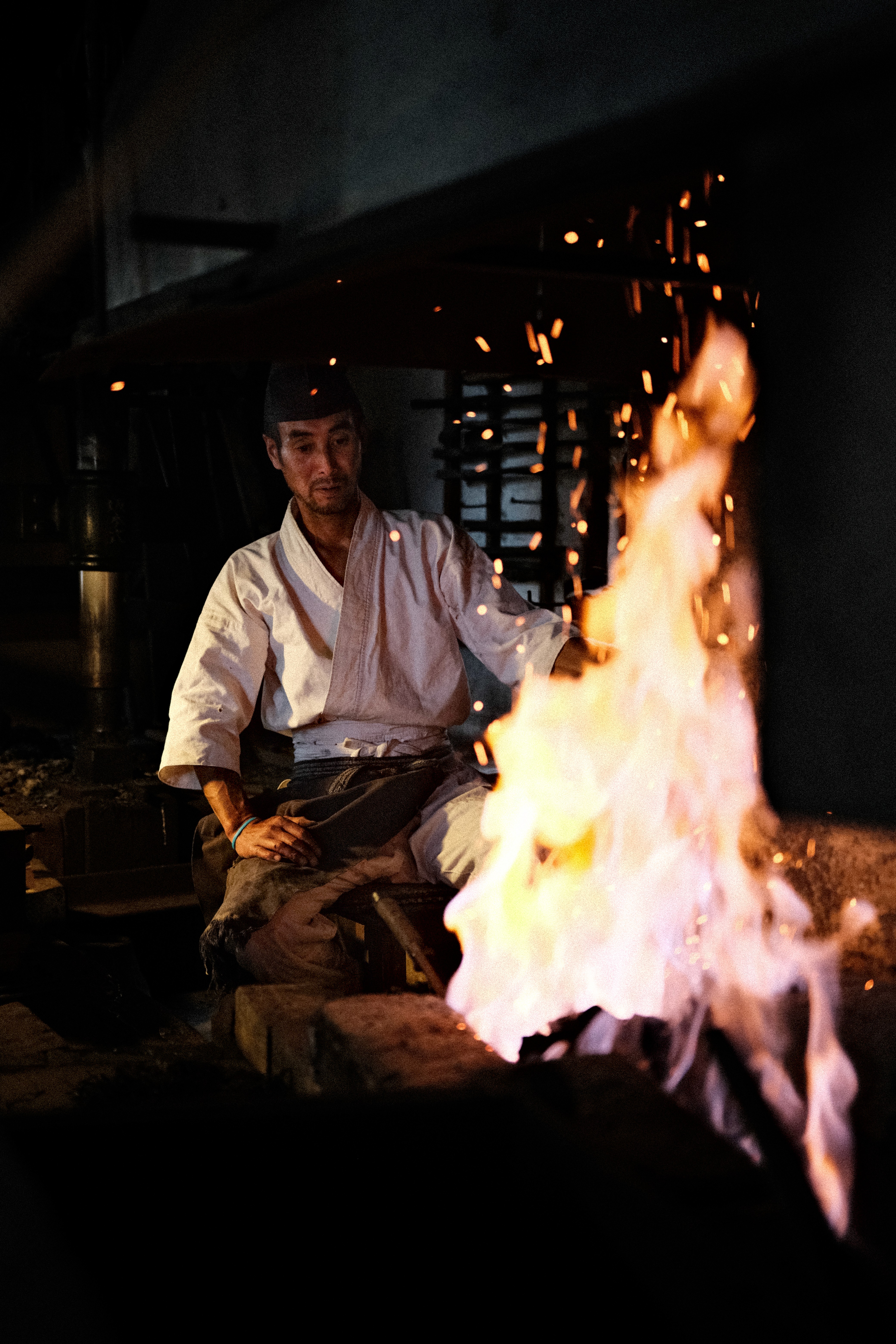 Swordsmiths hammering iron in a team