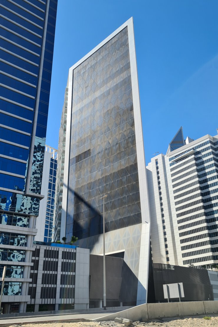 Close-up of the glass exterior at Marquise Square. We provide specialized real estate services for upscale buyers.