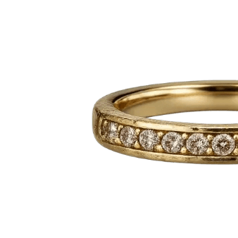 Gold ring with embedded diamonds on a white background