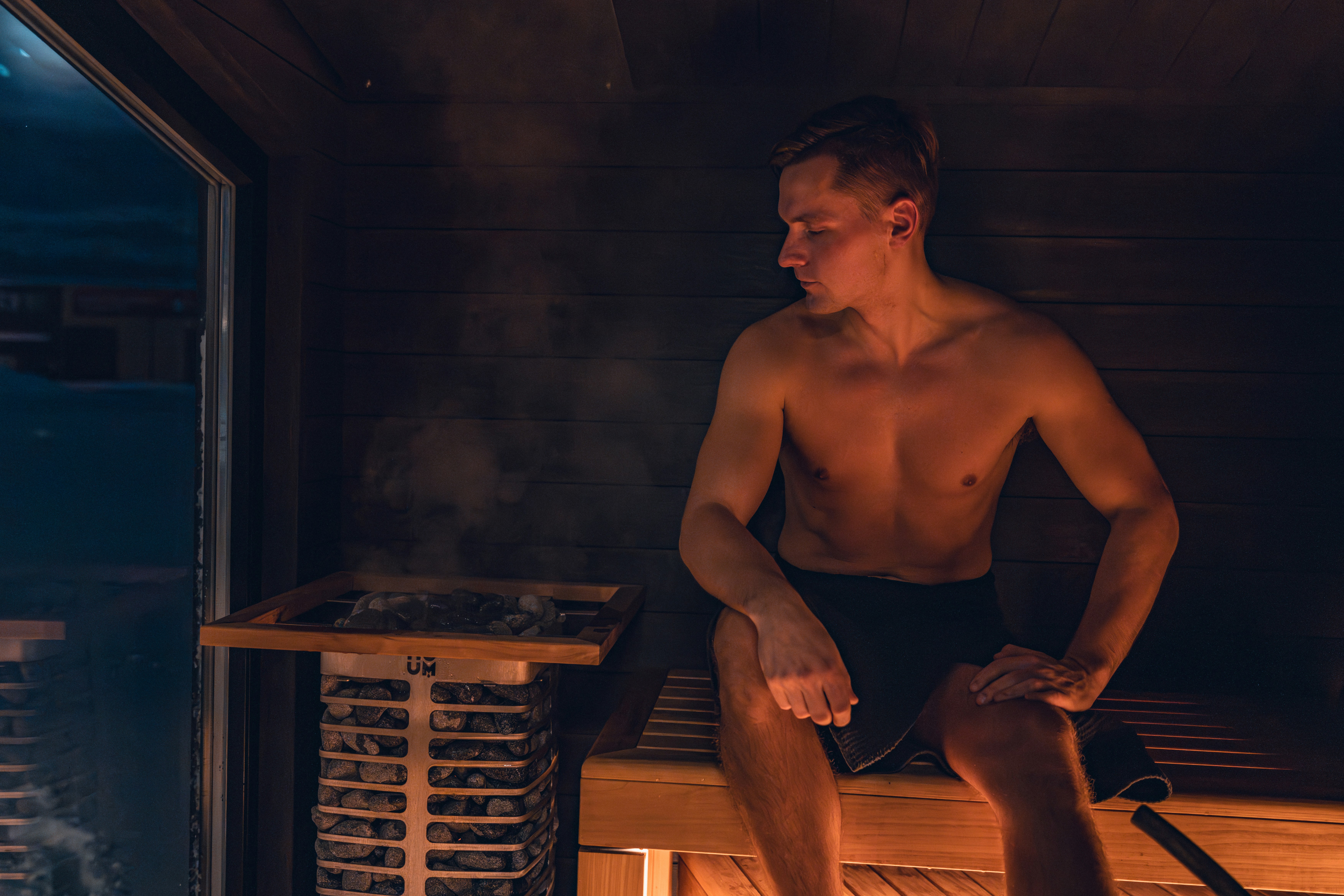 Man is relaxing in a hot sauna.