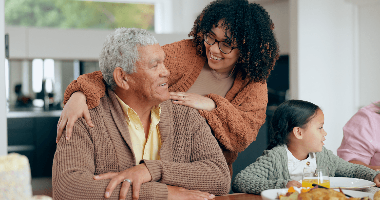 Elderly Father and Daughter Sitting at the Table