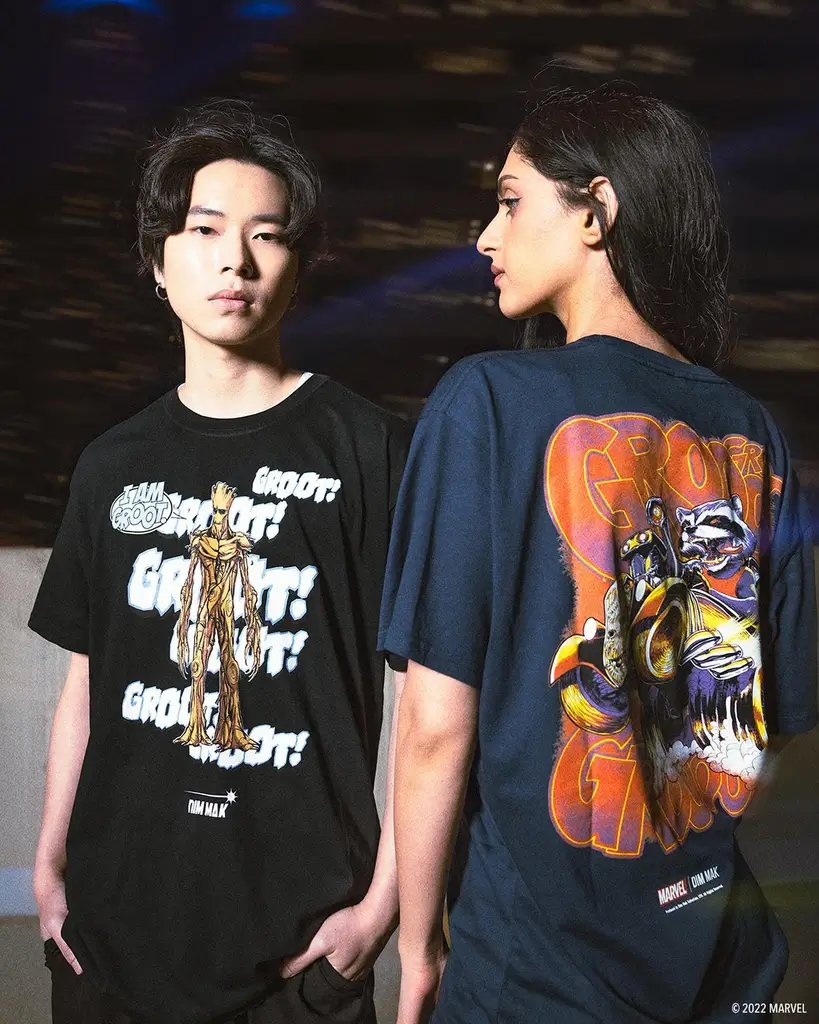 MrBeast, a young man with short hair wearing a black t-shirt, looking thoughtfully to the side against a gray background.