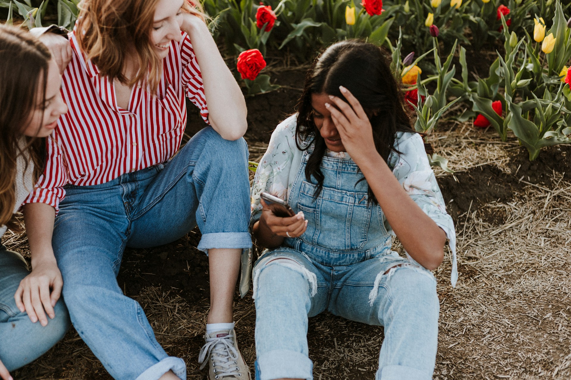 women fitting around a phone
