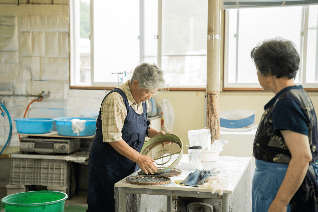 Craftsmen working on indigo dyeing patterns