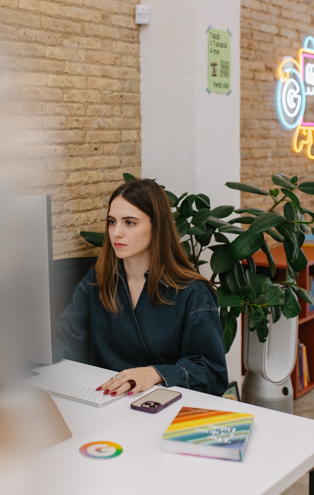 A woman working behind her desk in the studio