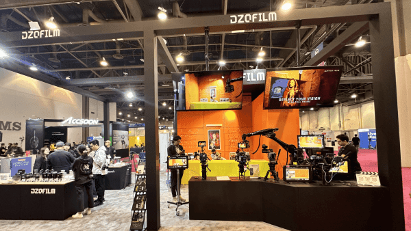 DZOFILM NAB Show booth with camera product displays, AV presentation structure, operator-facing demo area, and broadcast equipment viewing space