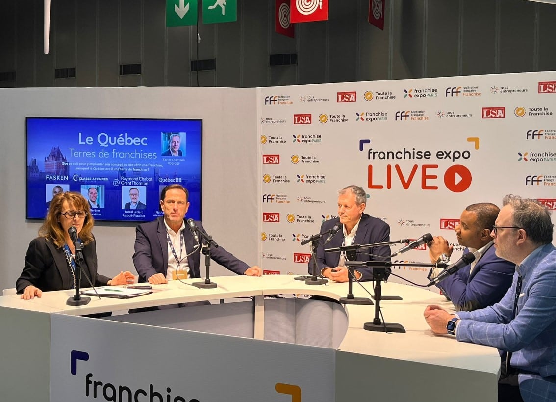 A disco ball hangs from a white ceiling.