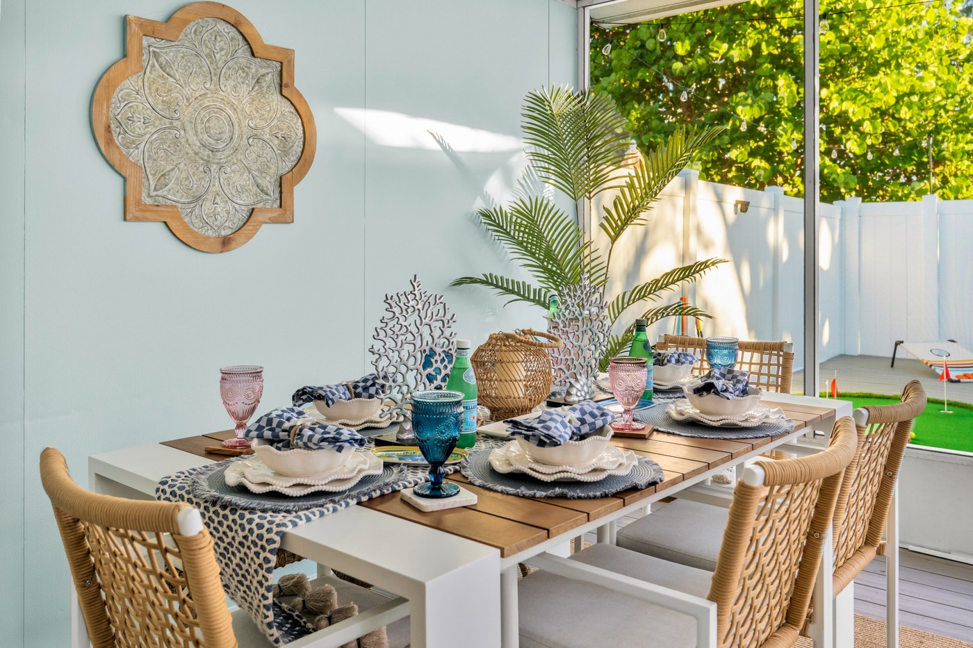 Screened outdoor dining area with table and chairs at an Anna Maria Island vacation rental, photographed for a listing