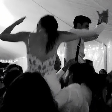 The bride and groom celebrating with NightStyle DJs at their wedding in Muskoka, surrounded by music, laughter, and a lively atmosphere.