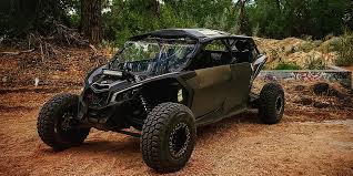 Young man in black leather double-breasted jacket jeans looking at the bottom