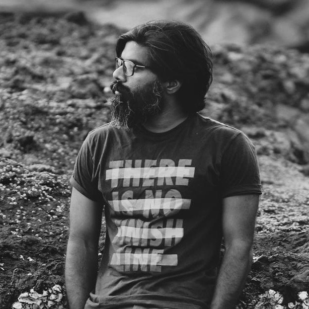 A woman with red hair is standing in the grass