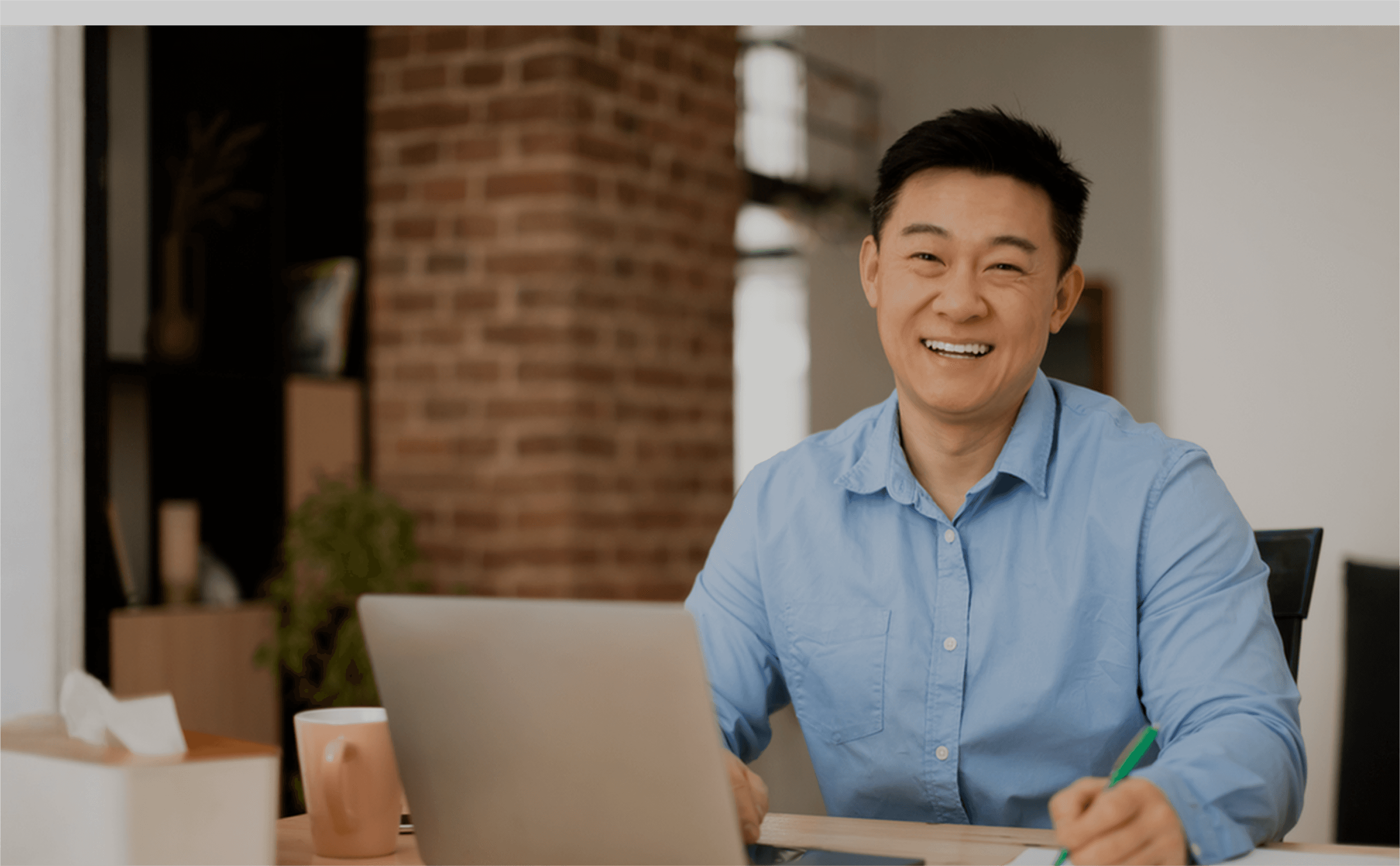 happy-asian-middle-aged-man-working-on-laptop