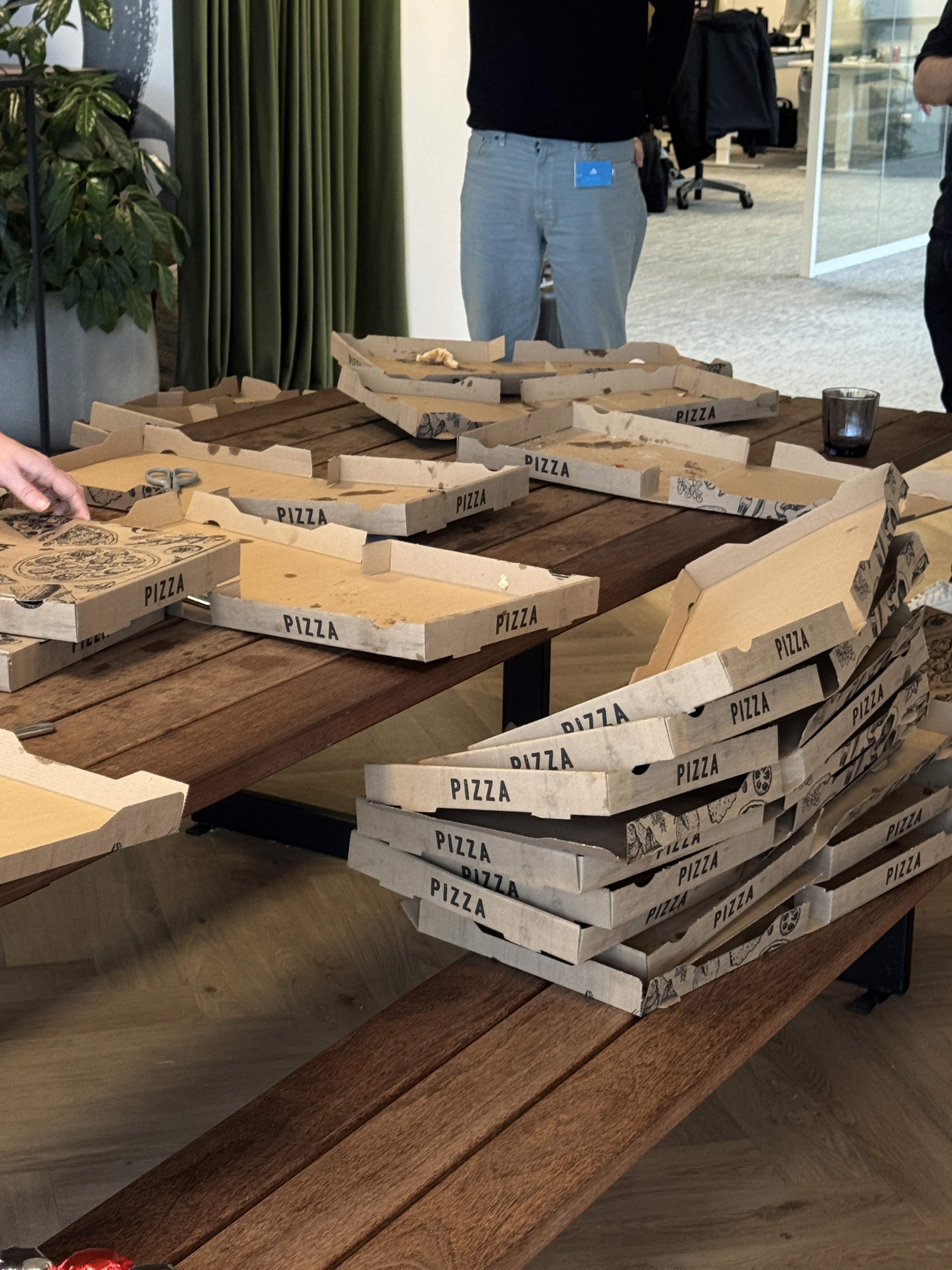 Two people talking on a rooftop at sunset