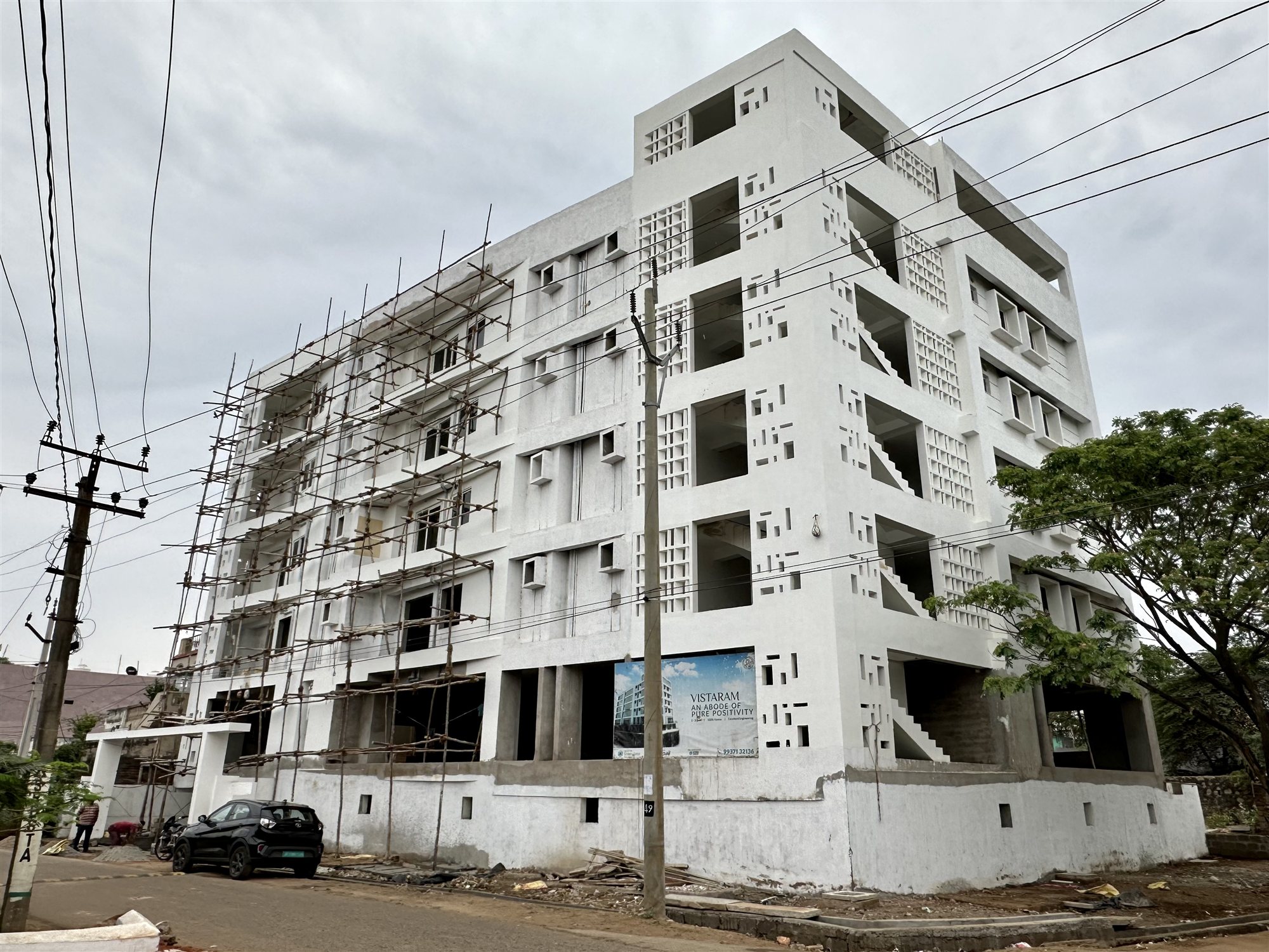 Five-storey white mixed-use building in Vizianagaram, its lower floors built with Agrocrete® Hollow Blocks