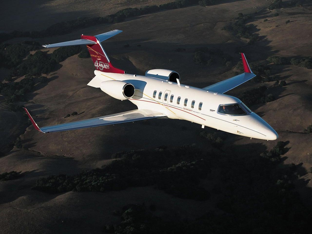 The Learjet 40 and Learjet 45 are two popular business jets produced by Bombardier Aerospace. Here is a comparison of their specifications:     Dimensions: The Learjet 40 has a length of 58.1 feet, a wingspan of 43.9 feet, and a height of 14.4 feet. The Learjet 45 has a length of 58.9 feet, a wingspan of 47.8 feet, and a height of 14.0 feet.     Maximum Range: The Learjet 40 has a maximum range of 1,961 nautical miles, while the Learjet 45 has a maximum range of 2,120 nautical miles.     Maximum Cruise Speed: The Learjet 40 has a maximum cruise speed of Mach 0.76, while the Learjet 45 has a maximum cruise speed of Mach 0.81.     Passenger Capacity: The Learjet 40 has a standard seating capacity of 6-7 passengers, while the Learjet 45 has a standard seating capacity of 8-9 passengers.     Cabin Dimensions: The Learjet 40 has a cabin length of 17.7 feet, a cabin width of 4.9 feet, and a cabin height of 4.8 feet. The Learjet 45 has a cabin length of 19.8 feet, a cabin width of 5.1 feet, and a cabin height of 4.9 feet.     Take off Distance: The Learjet 40 requires a take off distance of 4,972 feet, while the Learjet 45 requires a take off distance of 5,080 feet.     Maximum Payload: The Learjet 40 has a maximum payload of 2,040 pounds, while the Learjet 45 has a maximum payload of 2,710 pounds.     Powerplant: The Learjet 40 is powered by two Honeywell TFE731-20AR-1B engines, each producing 3,500 pounds of thrust. The Learjet 45 is powered by two Honeywell TFE731-20BR-1B engines, each producing 3,822 pounds of thrust.     Avionics: Both the Learjet 40 and Learjet 45 feature a Collins Pro Line 4 avionics system, with a four-screen EFIS display and dual FMS.     Overall, the Learjet 45 has a longer range, faster cruise speed, and larger cabin compared to the Learjet 40, but the Learjet 40 has a slightly lower take off distance and can be operated with fewer passengers.