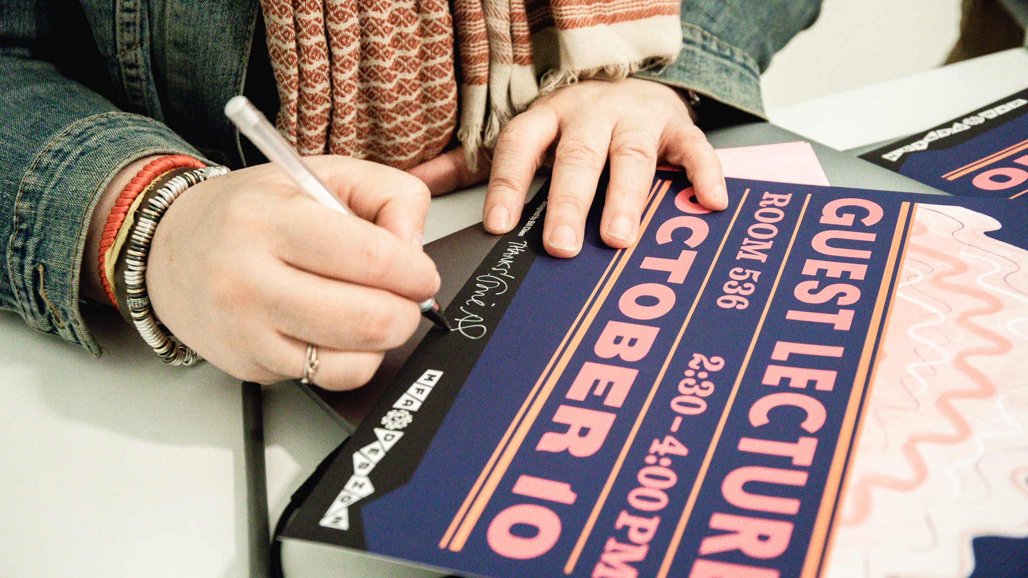 Gail Anderson signing a poster