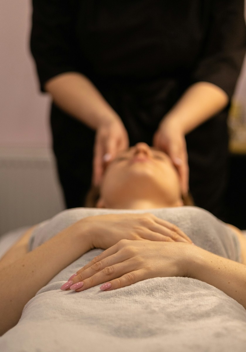Woman placing hand gently on another woman during a breathwork session.