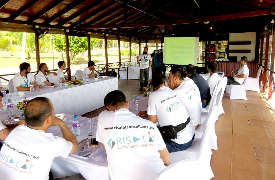 Participants at a Risalat workshop in an open-air pavilion