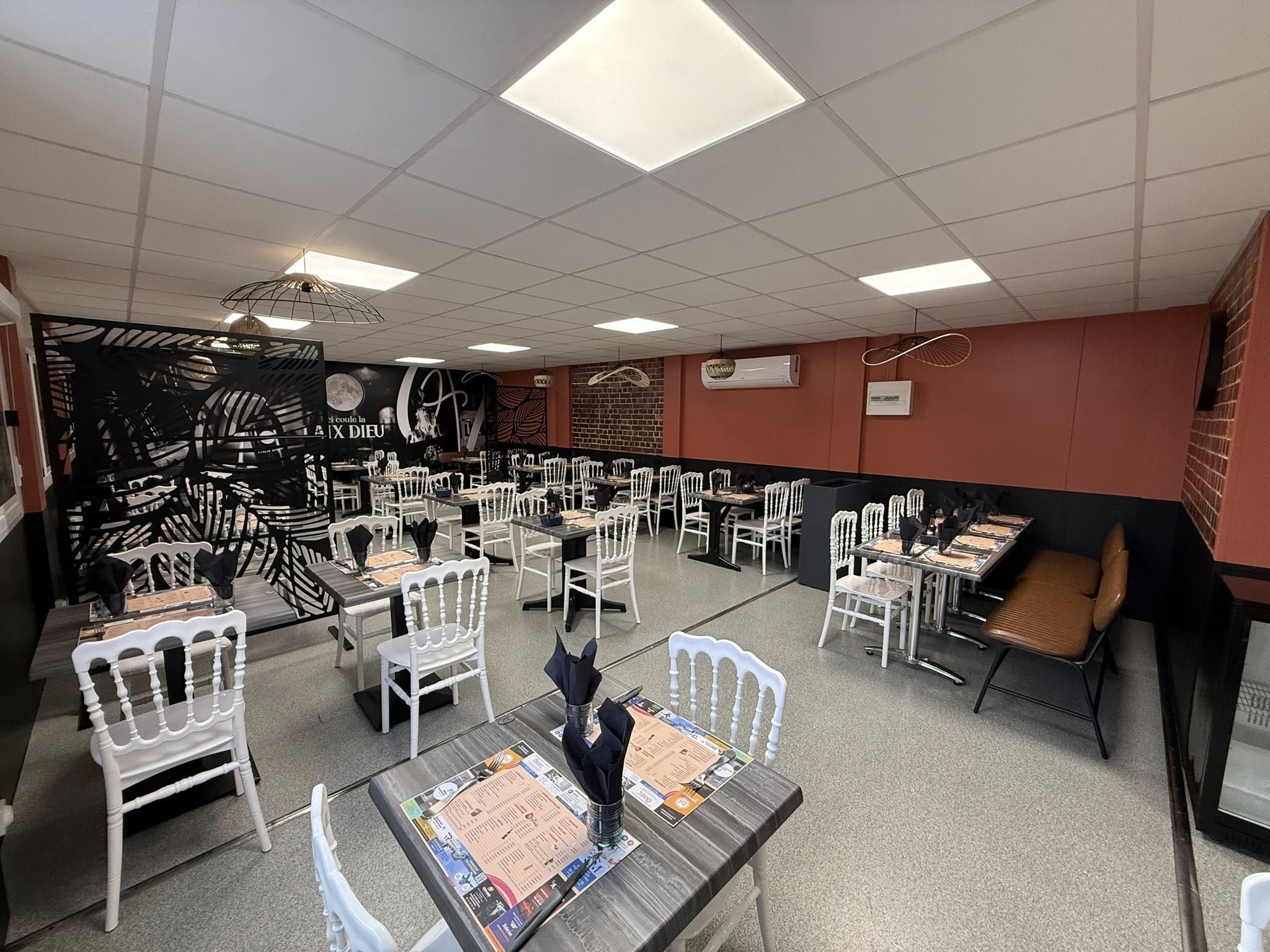 Modern living room with vertical garden, yellow sofas, and stylish coffee tables.