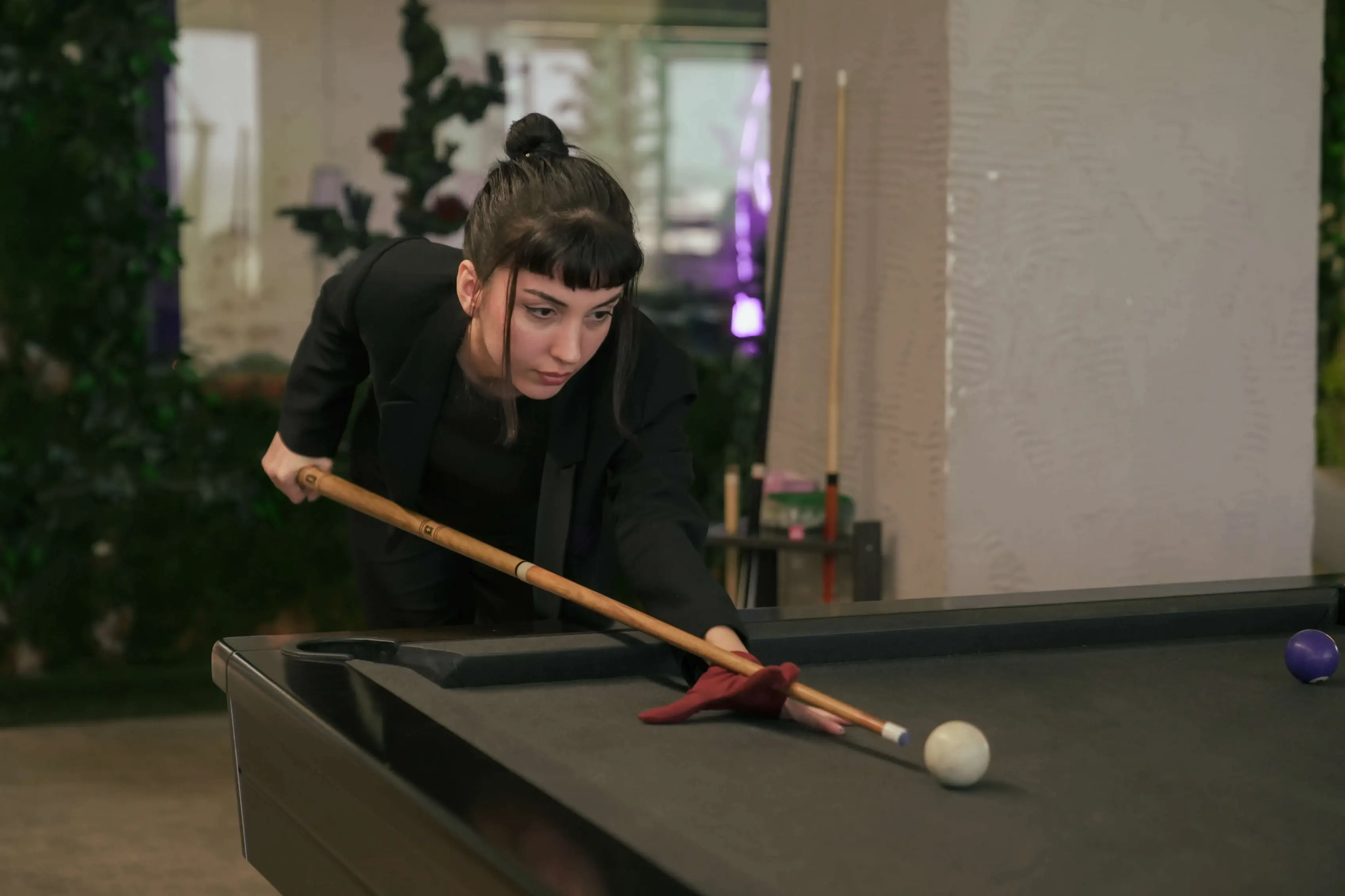 Neon Apps team member playing pool in the office recreational area, representing work-life balance.