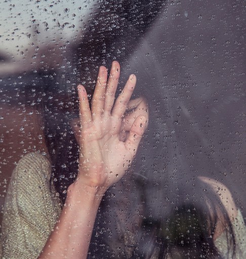 woman touch rainy glass