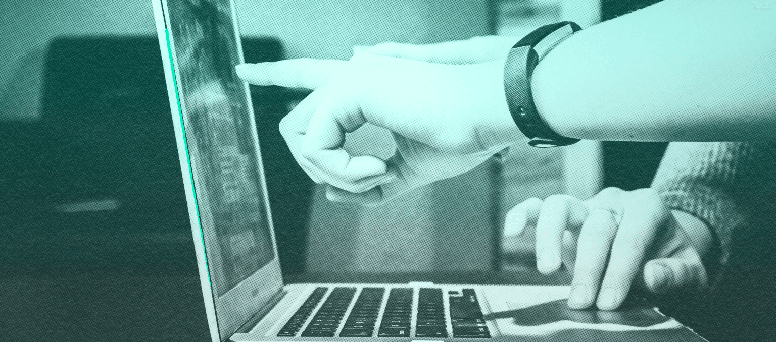 Team members reviewing an email campaign together on a laptop, symbolizing shared responsibility and cross-functional email marketing QA.