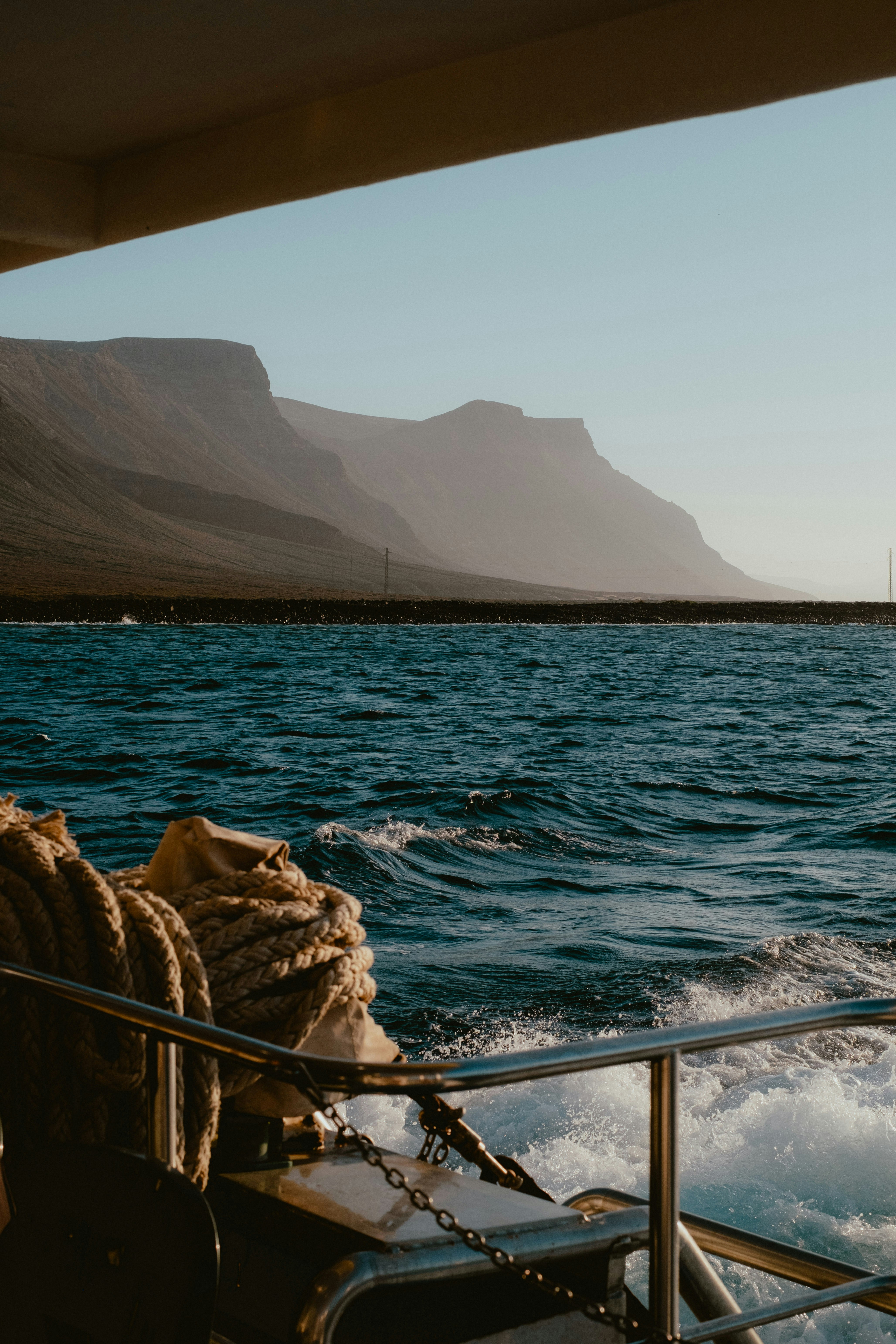 Sailing past mountains on a sunny day