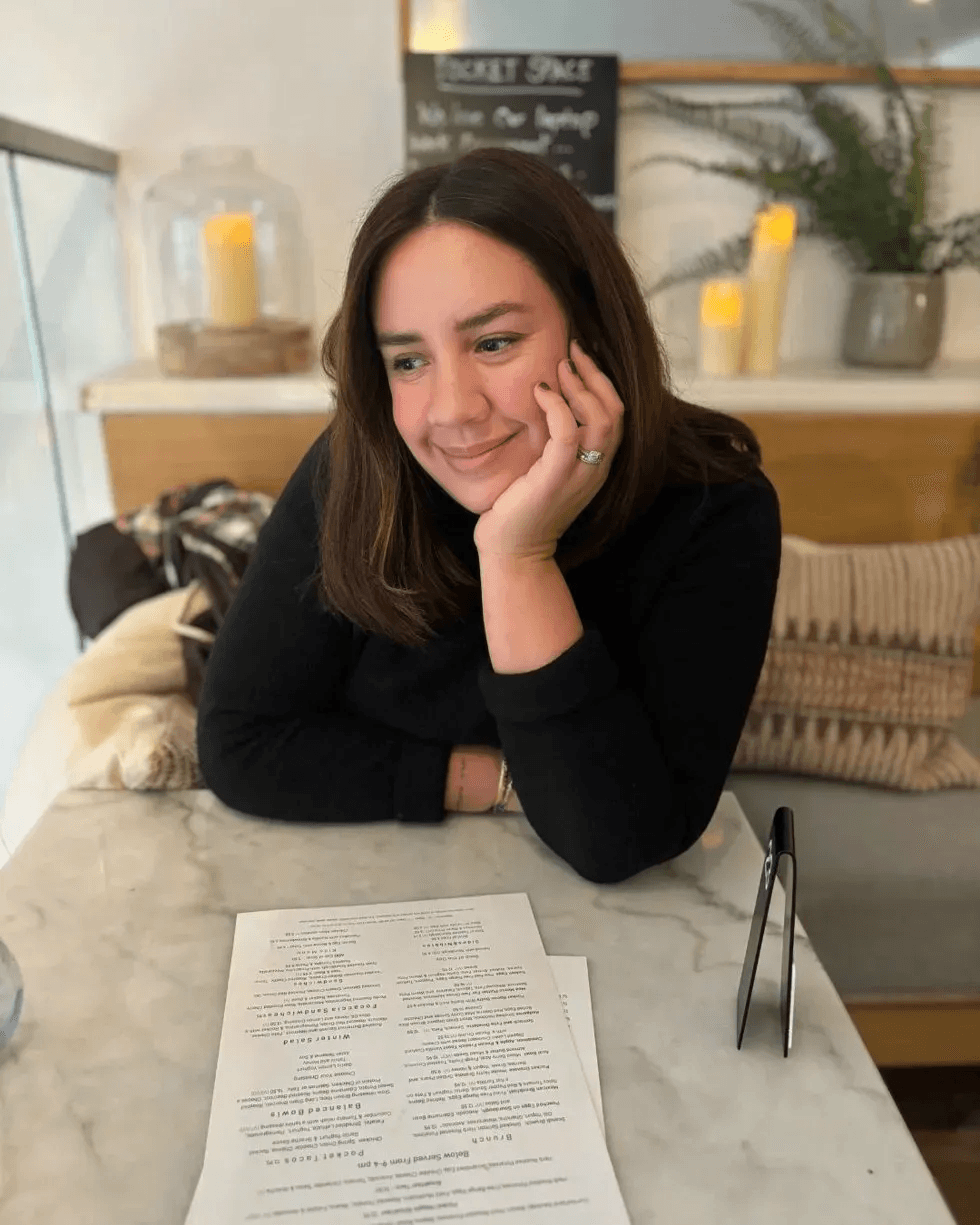 Catherine smiling at marble table