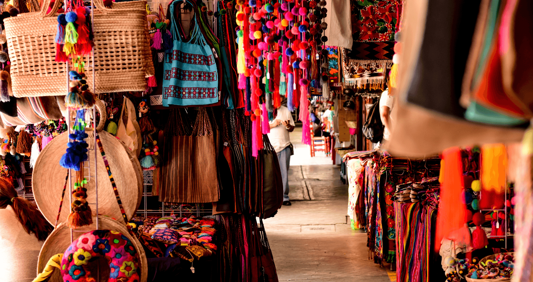 Shoppers browsing diverse vendor stalls at a lively and colorful indoor swap meet"
