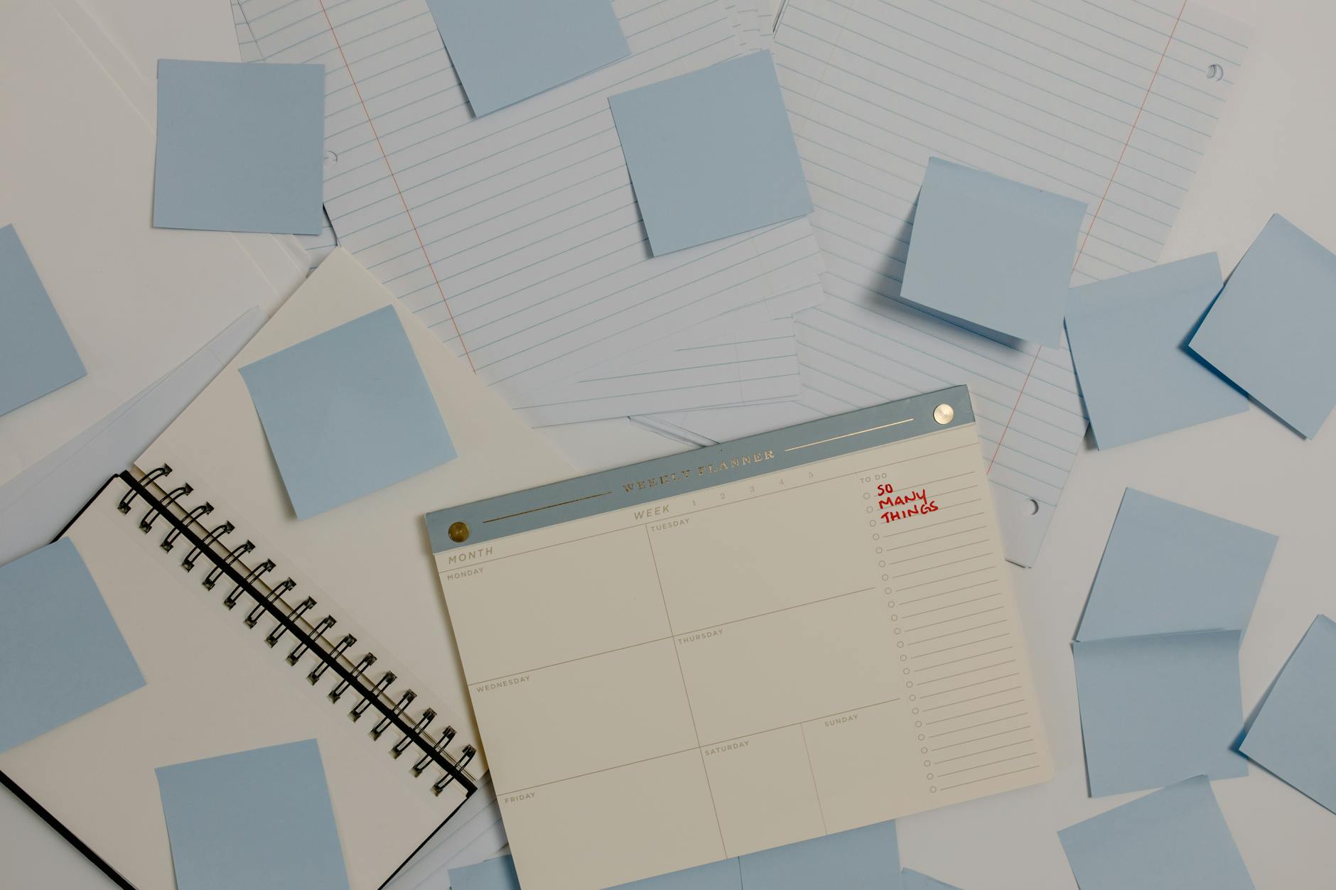 A teachers hand placing a printed schedule card into a blue nylon pocket chart hanging on a wall.