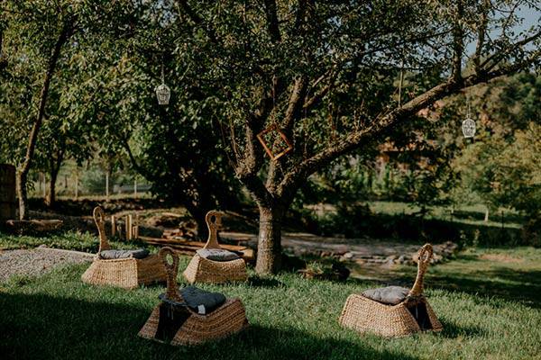 A woman in jeans jacket, holding a camera.