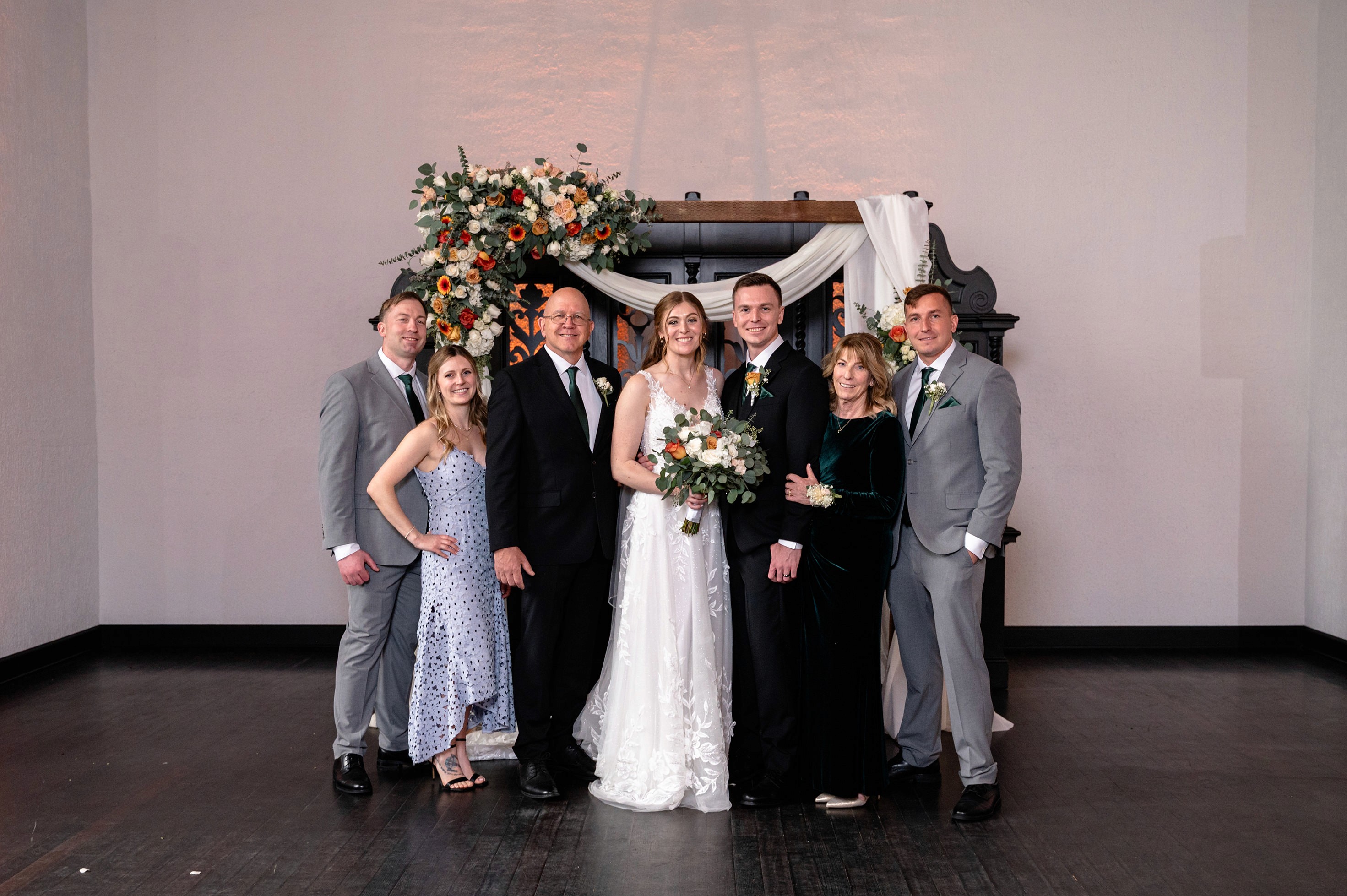 Flat lay wedding details with bouquet, rings, and sparkling bridal heels