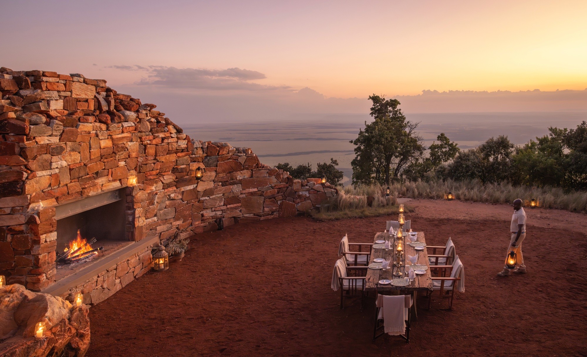 A stone-hearth dinner set high above the sweep of the Mara