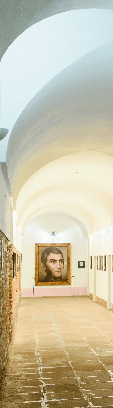 Portrait of a person in a pink sweater against a light background