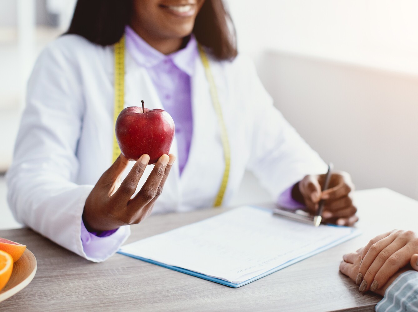 person meeting with a dietitian to create a diet plan to support taking top weight loss tablets