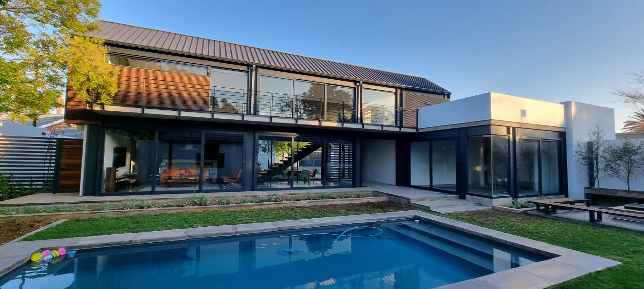 Futuristic black and white concept car with sleek rounded design and city skyline in background.