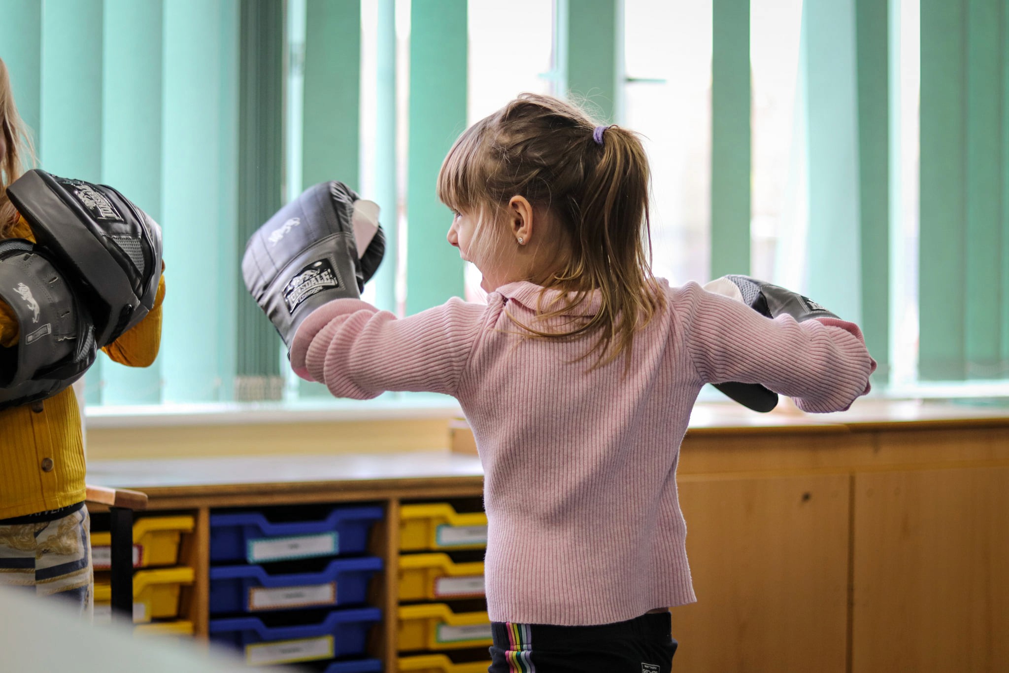 Young boy jumps through hoops during outdoor activity.