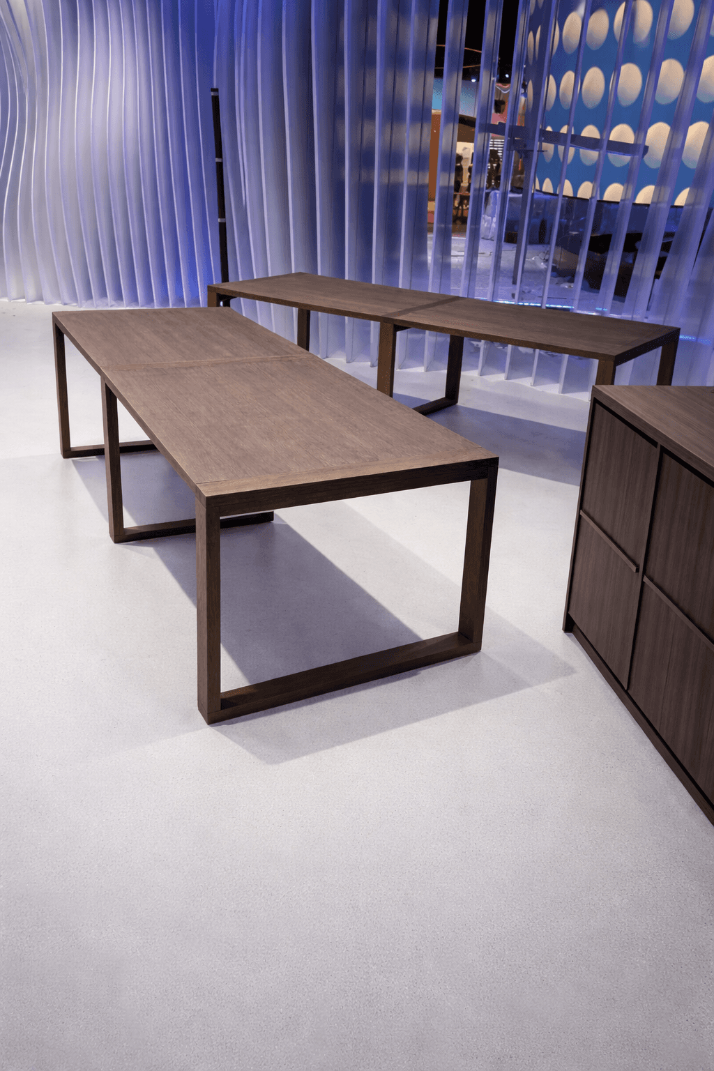 Mossy rocks on a beach with sea stacks at sunset.