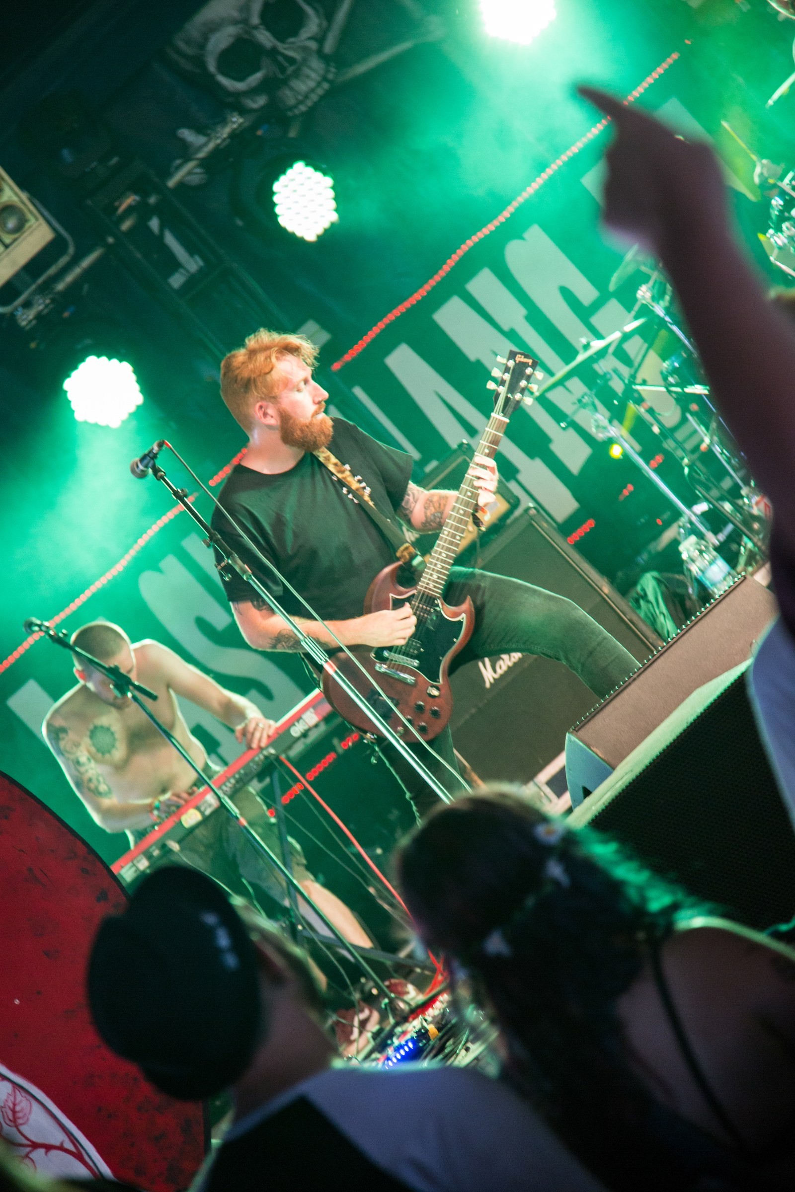 EVENTS · A live performance under green stage lights.