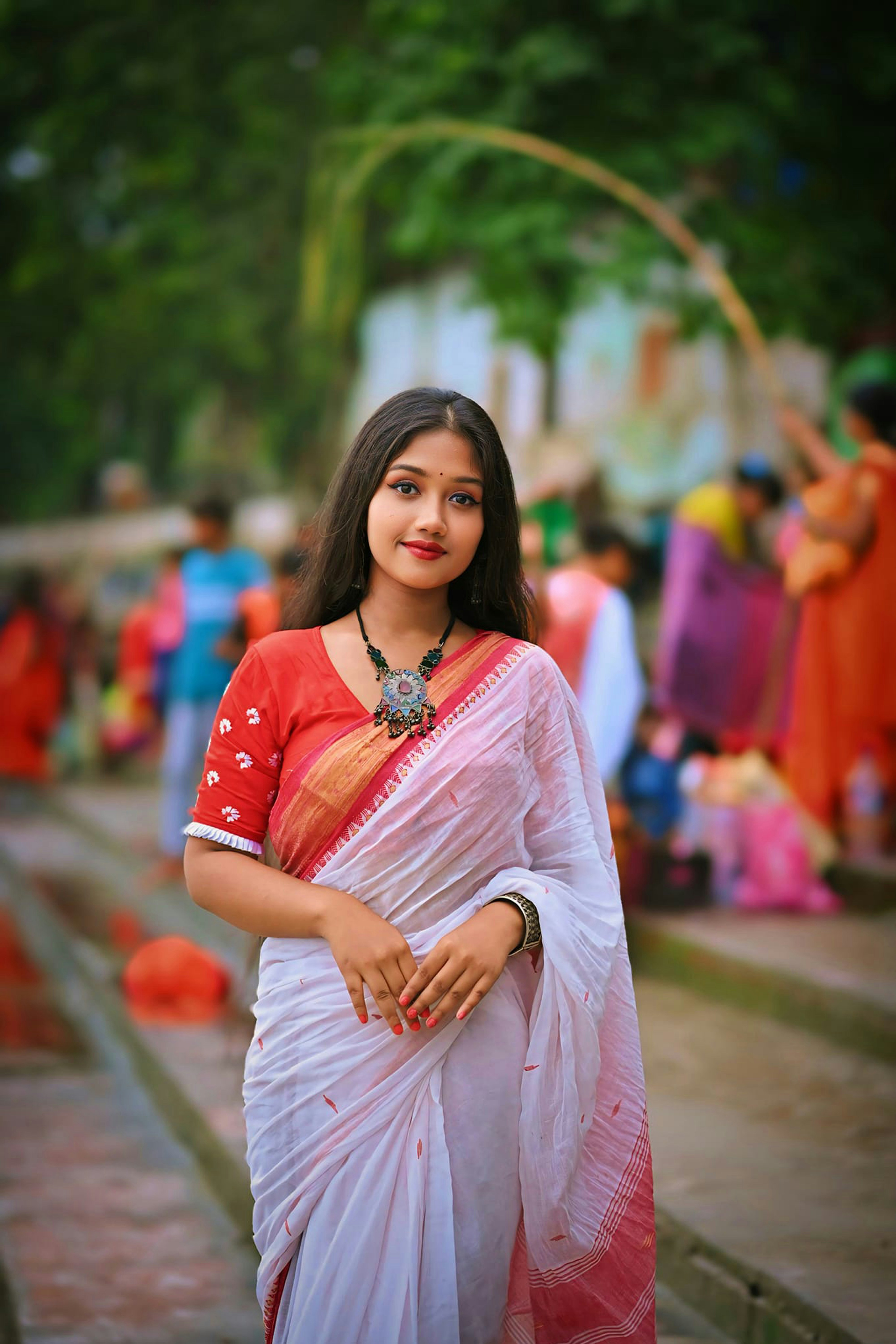 A woman in a red and white sari