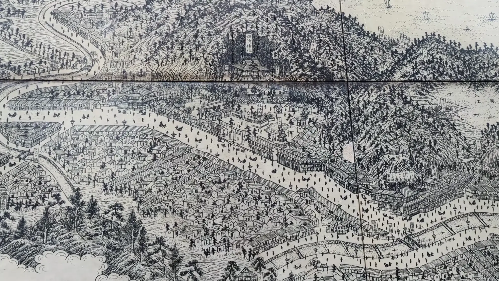 Detail of a historical woodblock panorama of Kinosaki with the canal running through its centre.
